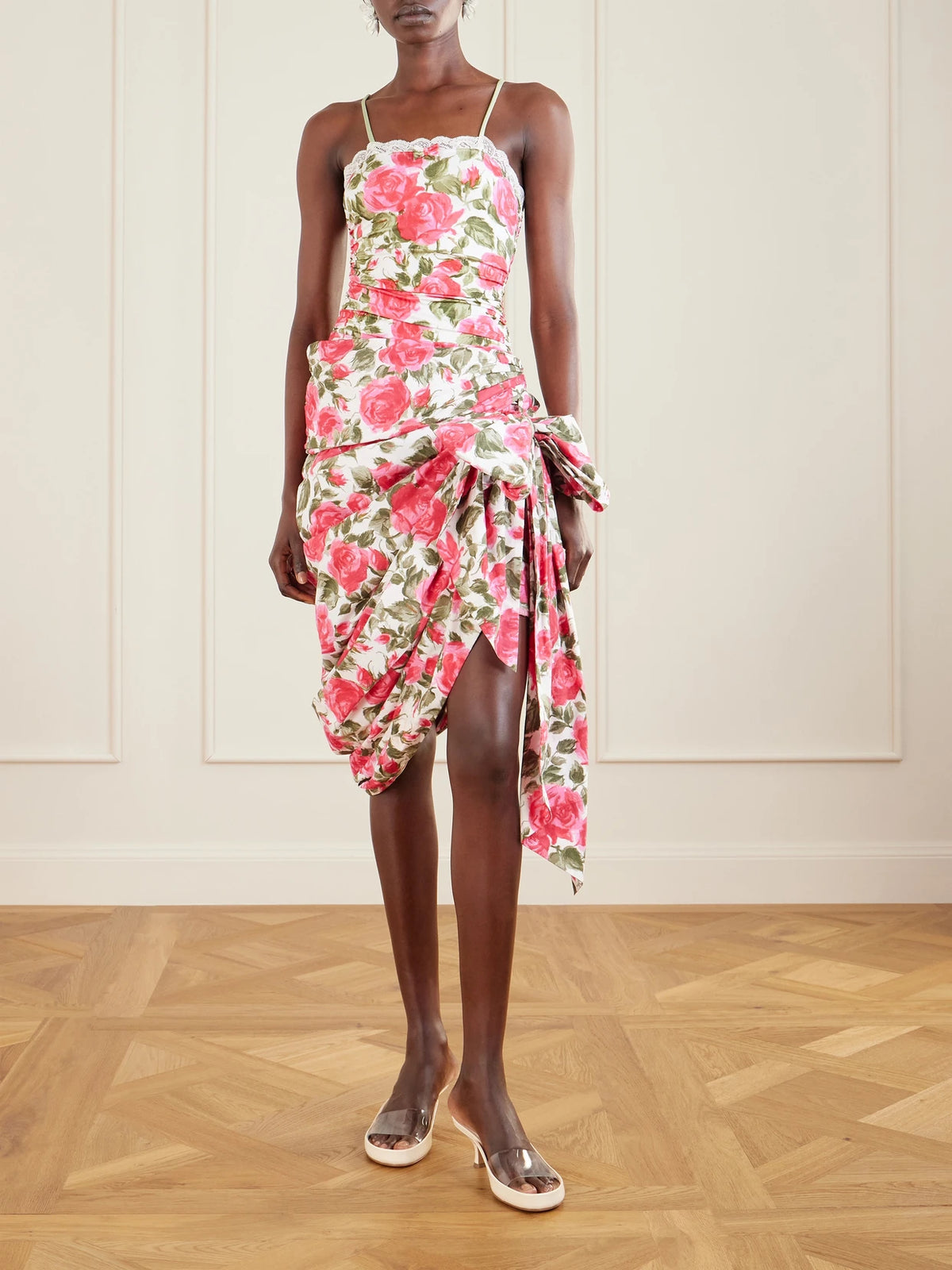 Image of a model wearing Skirts. Product name - Bow-detailed Ruched Floral-print Cotton-poplin Mini Skirt in White colour by brand - Chloé