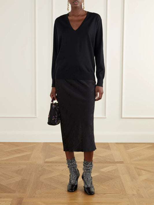 Image of a model wearing Outerwear. Product name - Ribbed Merino Wool Sweater in Black, Ecru colour by brand - Dries Van Noten