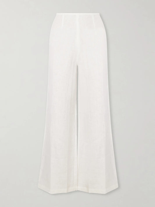 Image of a model wearing Pants. Product name - Syna Linen Straight-leg Pants in White colour by brand - Faithfull