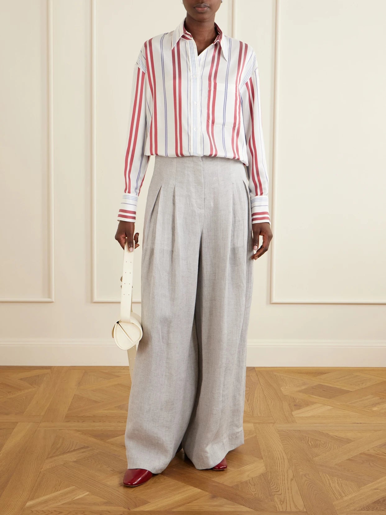 Image of a model wearing Tops. Product name - Big Joe Striped Silk Shirt in Blue colour by brand - TWP
