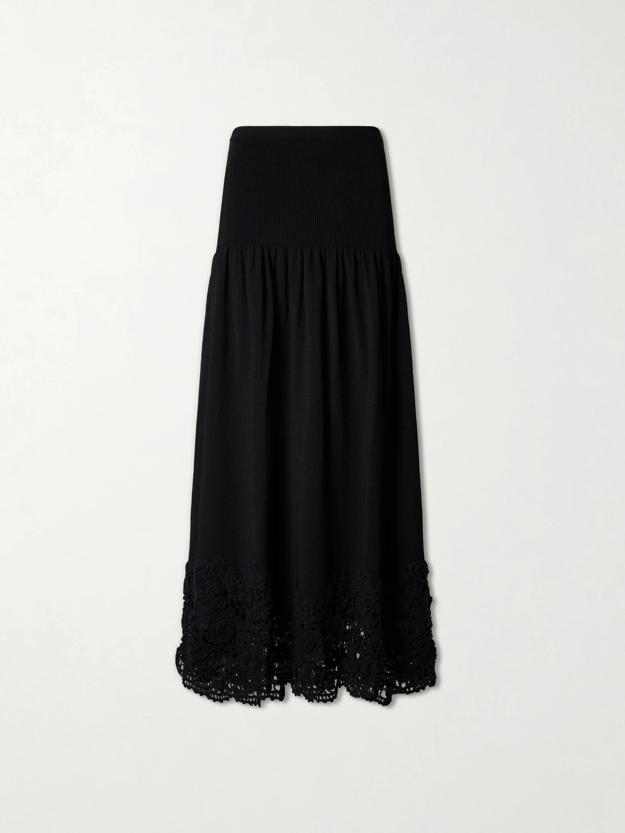 Image of a model wearing Skirts. Product name - Leona Crochet-trimmed Ribbed Midi Skirt in Black colour by brand - Ulla Johnson