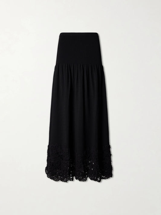 Image of a model wearing Skirts. Product name - Leona Crochet-trimmed Ribbed Midi Skirt in Black colour by brand - Ulla Johnson