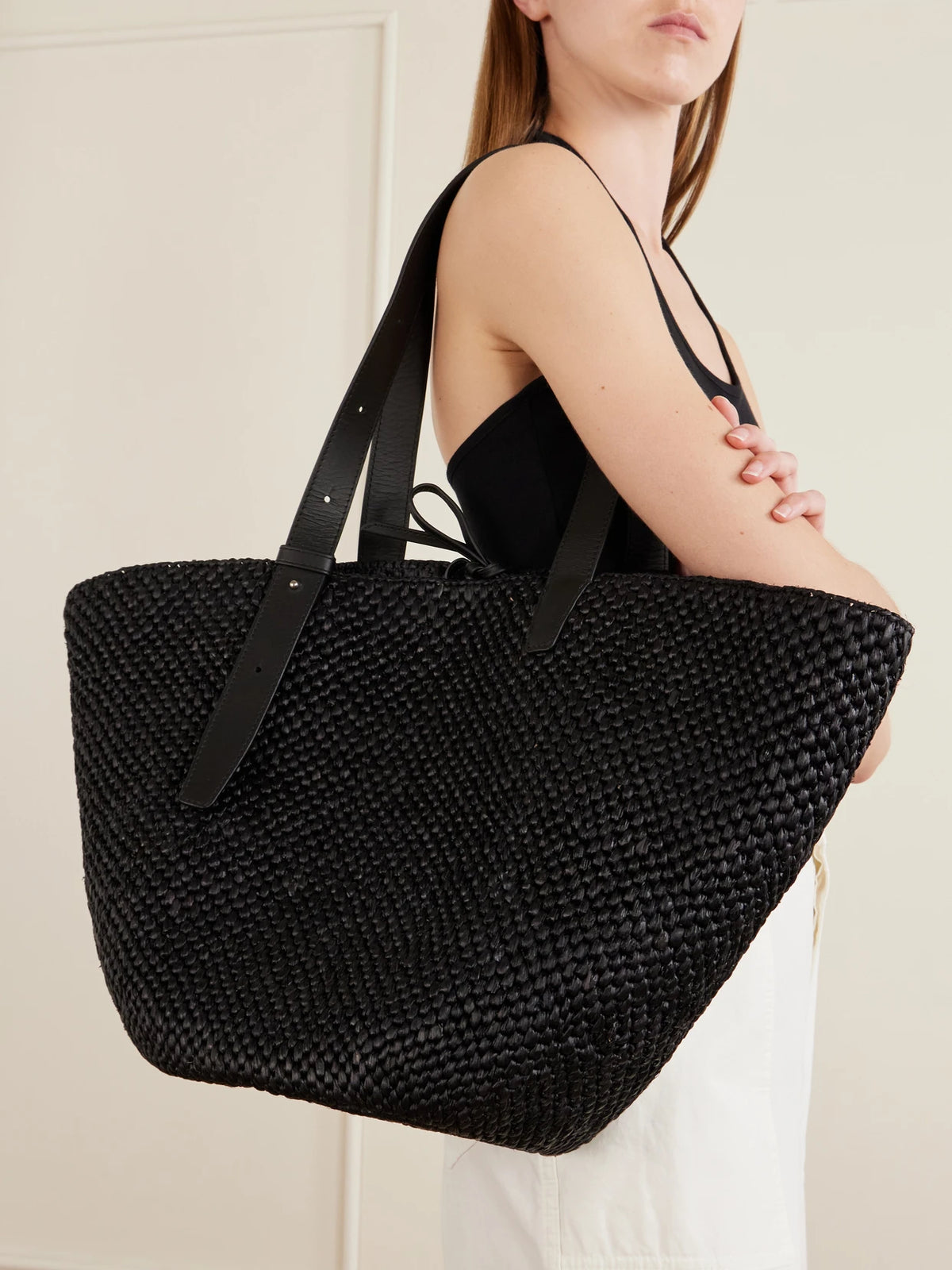 Image of Bags. Product name - The Bianca Leather-trimmed Raffia Tote in Black colour by brand - LIÉ STUDIO