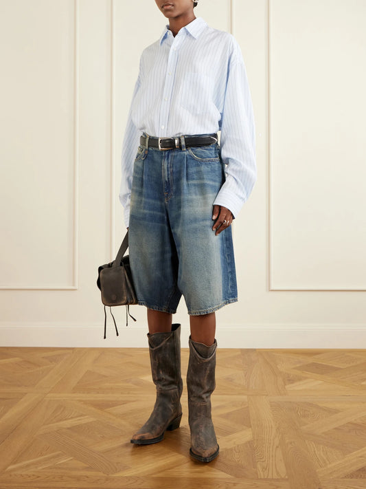Image of a model wearing Shorts. Product name - Jesse Denim Shorts in Mid denim colour by brand - R13