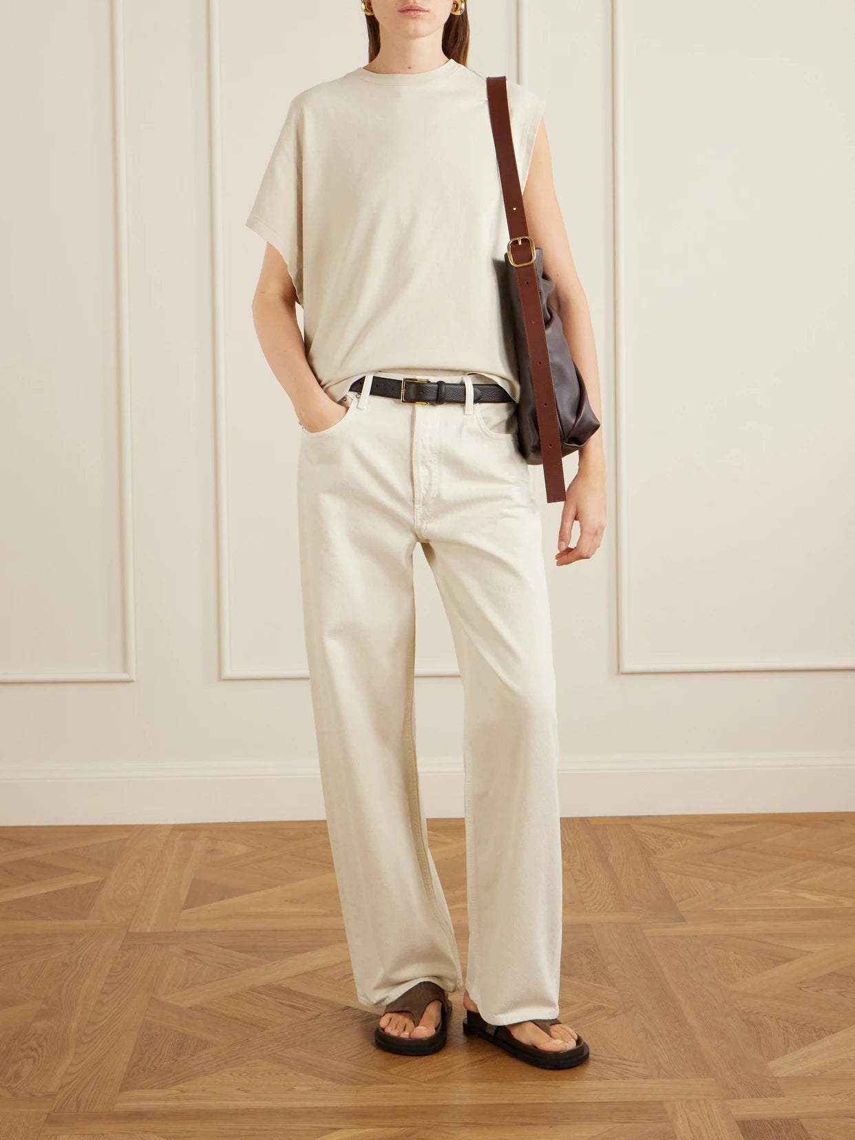 Image of a model wearing Tops. Product name - Corrine Asymmetrical Cotton-jersey T-shirt in Taupe colour by brand - AGOLDE
