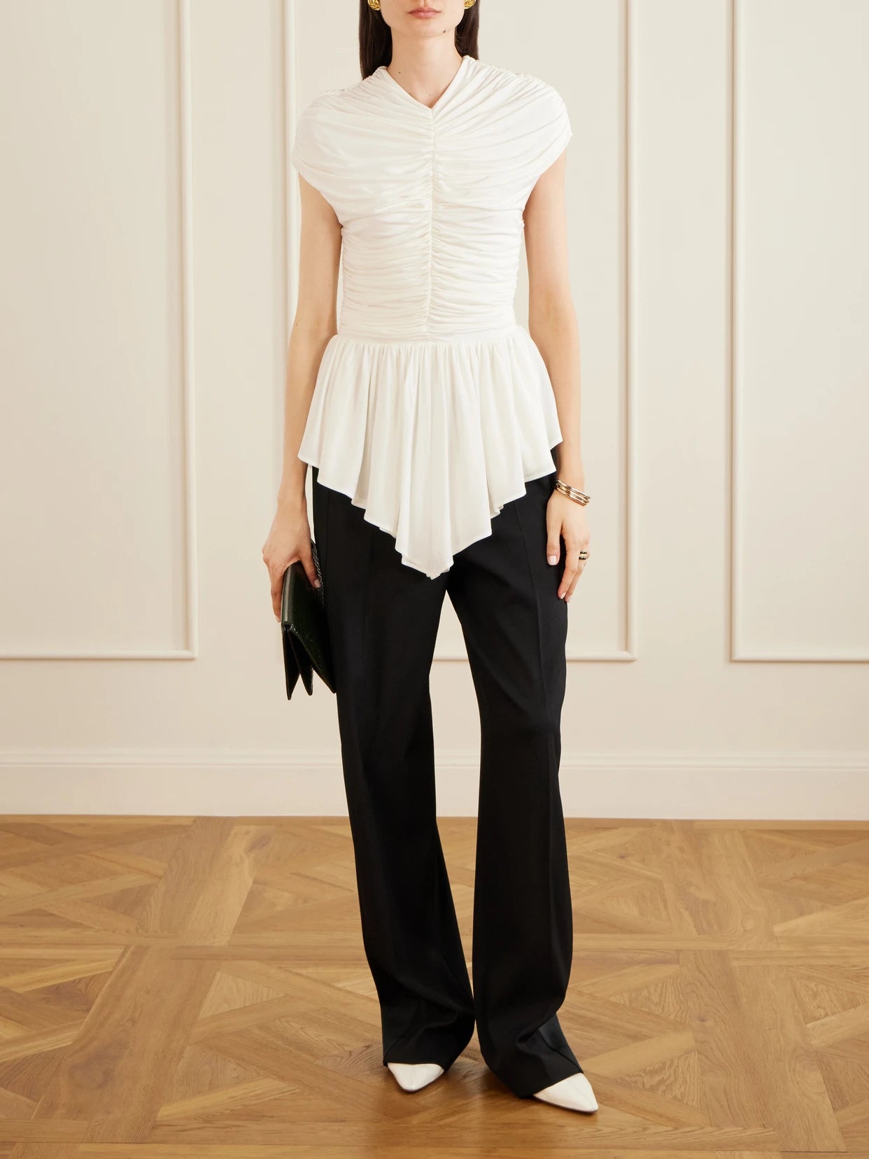 Image of a model wearing Tops. Product name - Gabor Ruched Ruffled Stretch-jersey Blouse in Pastel yellow colour by brand - TOVE
