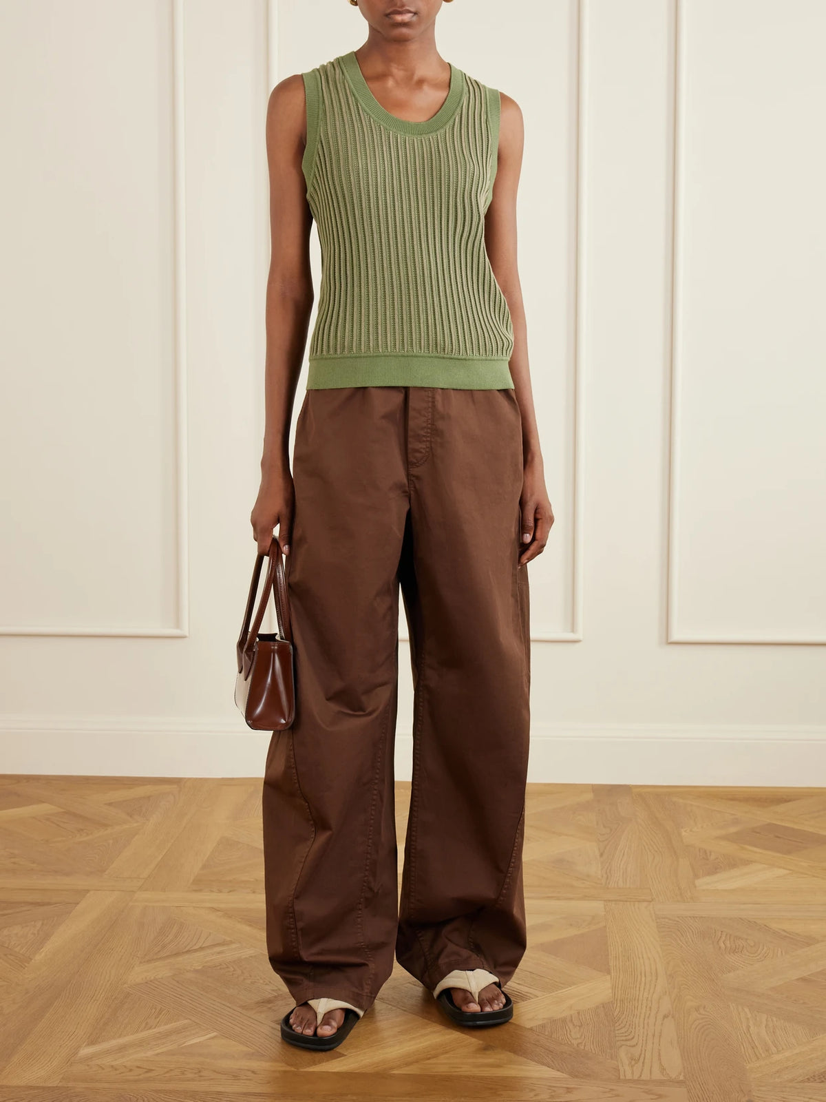 Image of a model wearing Pants. Product name - Garment-dyed Cotton-blend Gabardine Wide-leg Pants in Brown colour by brand - Tibi