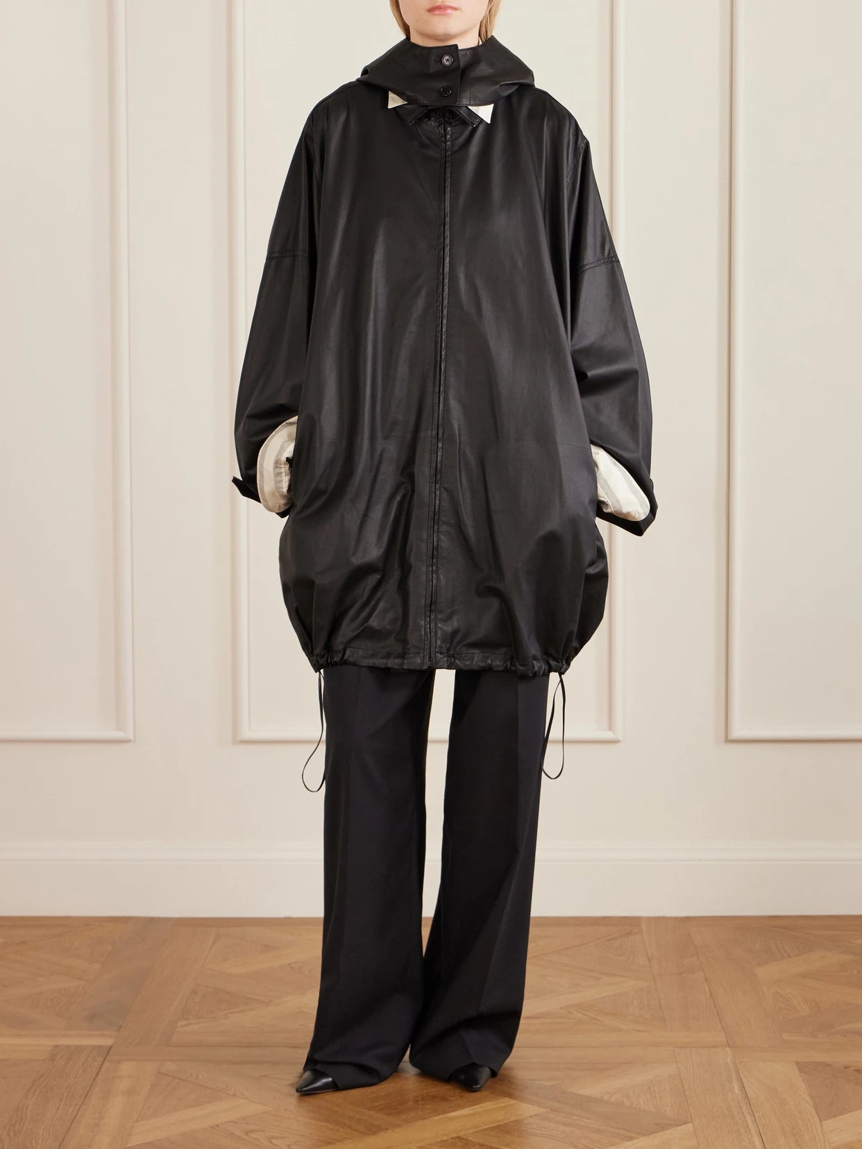 Image of Coats & Jackets. Product name - Cassandre Leather Hooded Coat in Black colour by brand - The Row