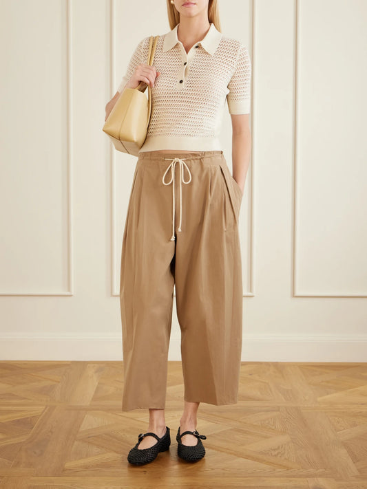 Image of a model wearing Pants. Product name - Organic Cotton-poplin Wide-leg Pants in Beige colour by brand - Maria McManus