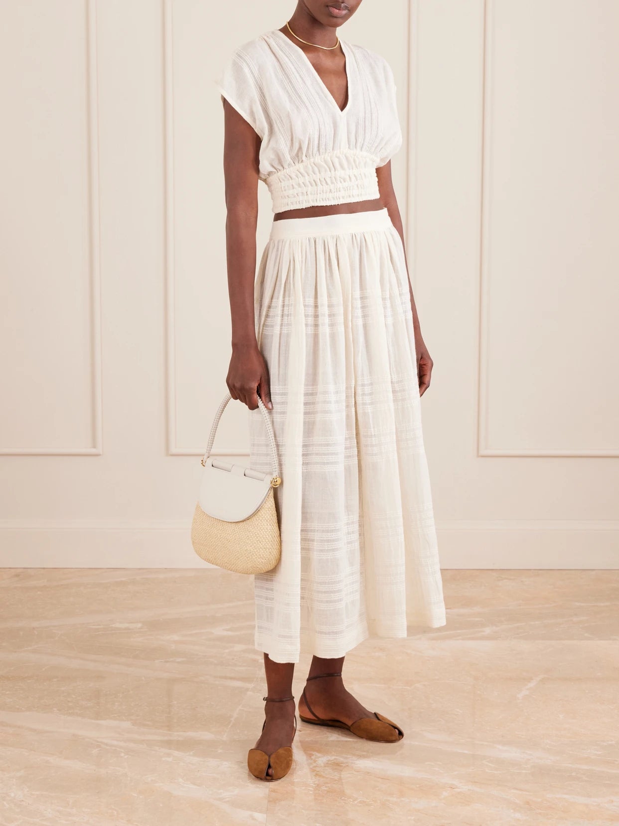 Image of a model wearing Tops. Product name - Alia Striped Cropped Cotton Top in Cream colour by brand - lemlem