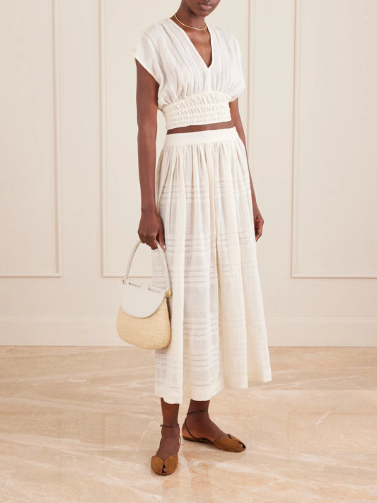 Image of a model wearing Tops. Product name - Alia Striped Cropped Cotton Top in Cream colour by brand - lemlem