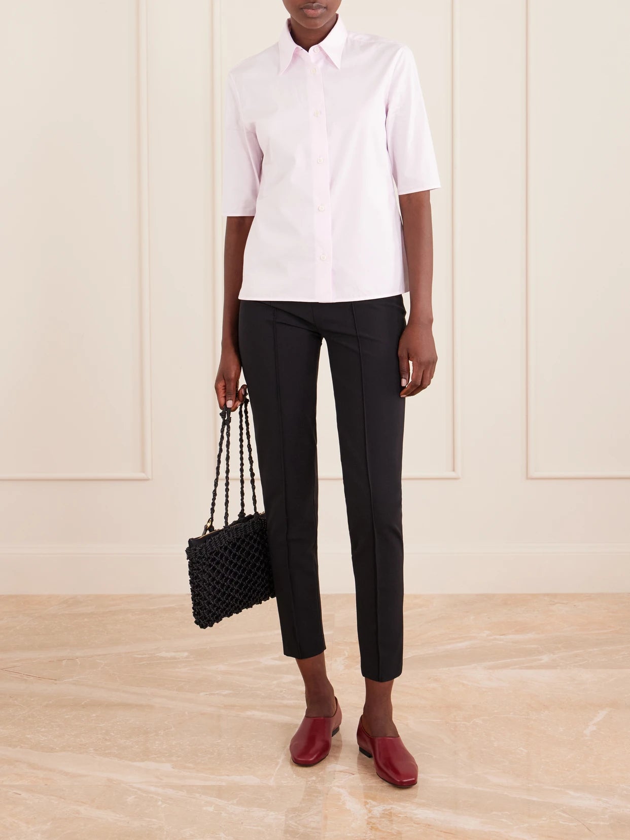 Image of a model wearing Pants. Product name - Stretch-jersey Skinny-leg Pants in Black colour by brand - Jil Sander