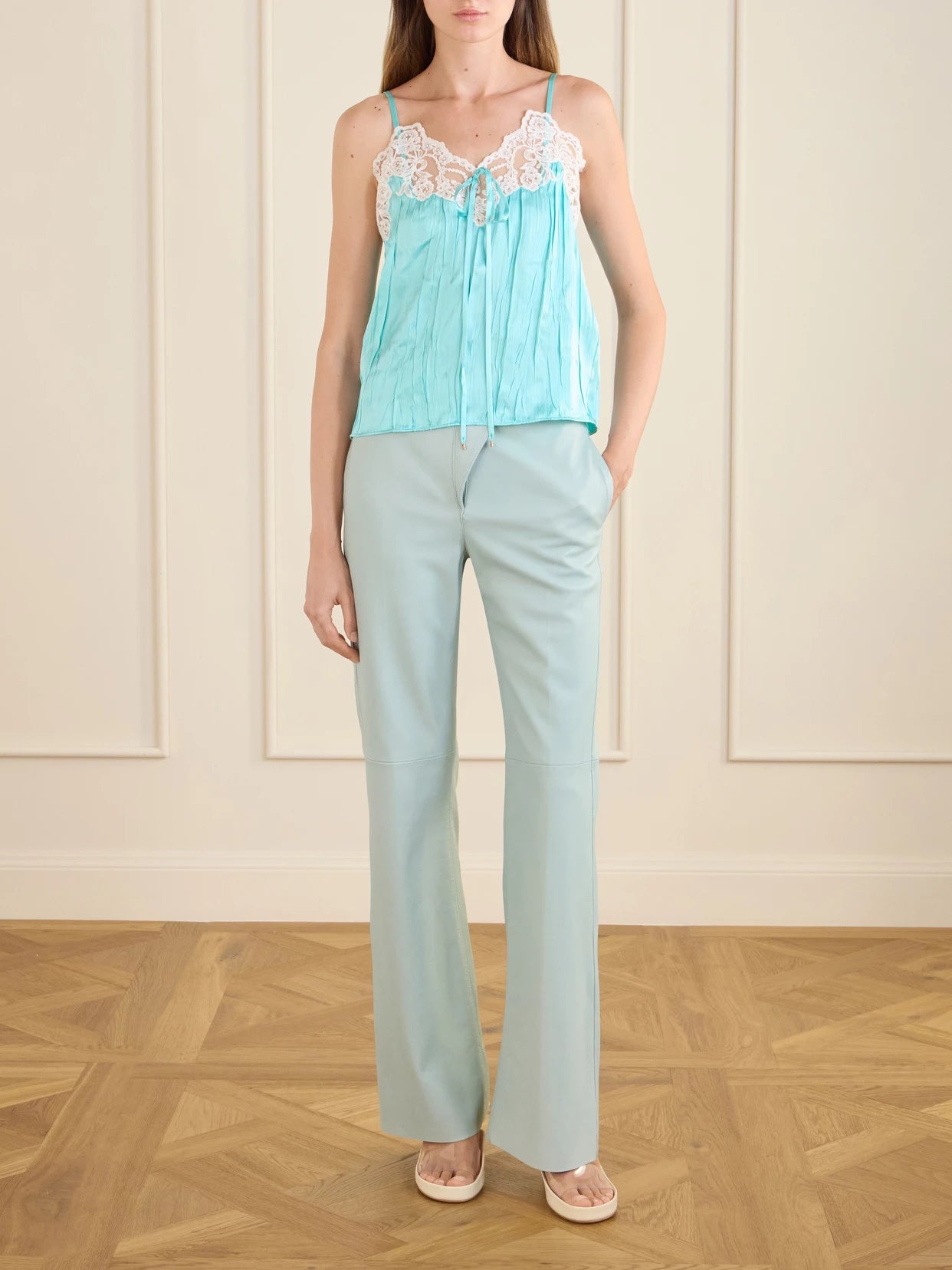 Image of a model wearing Pants. Product name - High-rise Paneled Leather Straight-leg Pants in Light blue colour by brand - Chloé