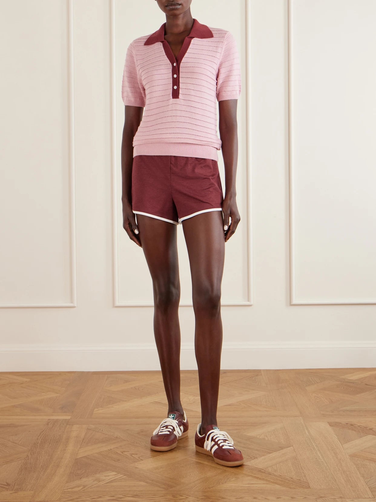 Image of a model wearing Outerwear. Product name - Wren Cotton-blend Knitted Polo Sweater in Pink colour by brand - Varley