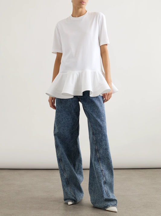 Image of a model wearing Tops. Product name - Oversized Poplin-trimmed Cotton-jersey Peplum T-shirt in White colour by brand - Alaïa