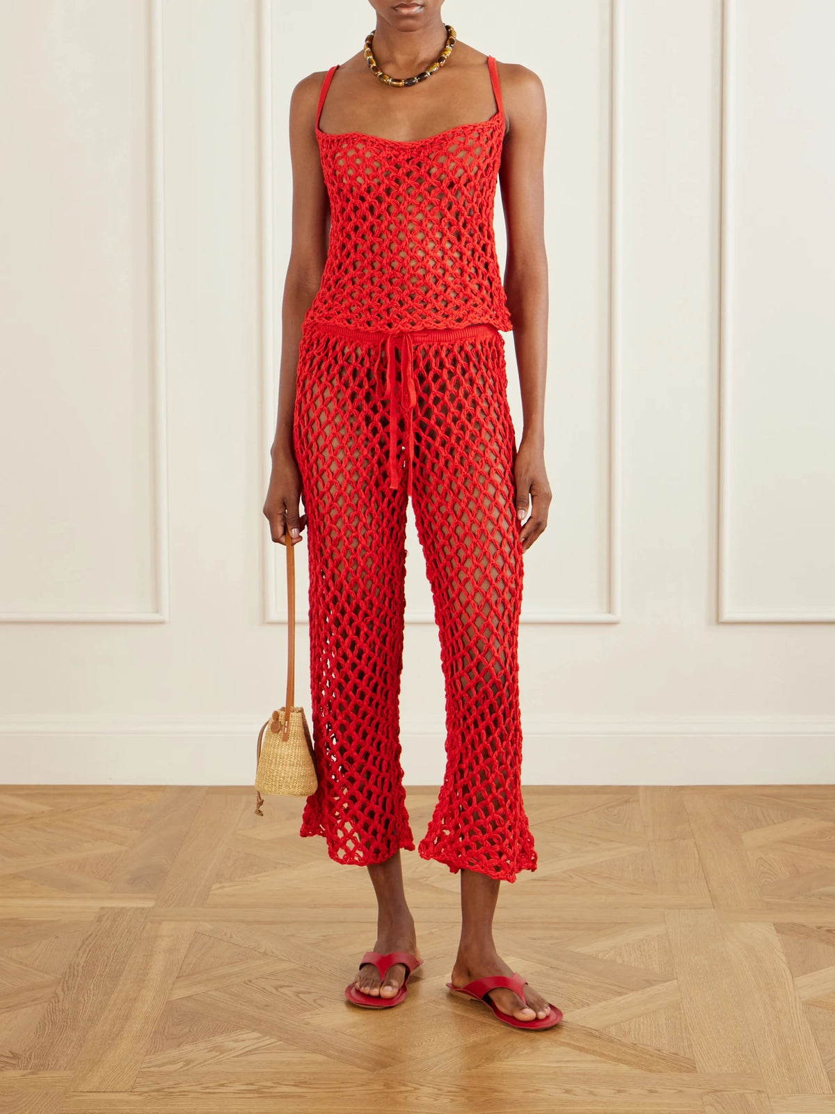 Image of a model wearing Tops. Product name - Clara Open-knit Tank in Red colour by brand - Haight