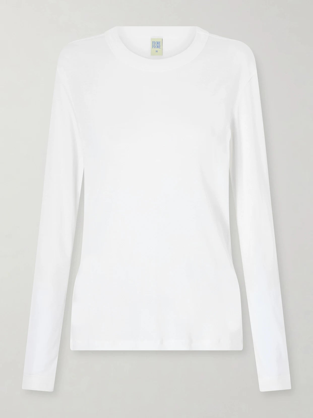 Image of a model wearing Tops. Product name - Sophie Organic Cotton-jersey T-shirt in White colour by brand - FLORE FLORE