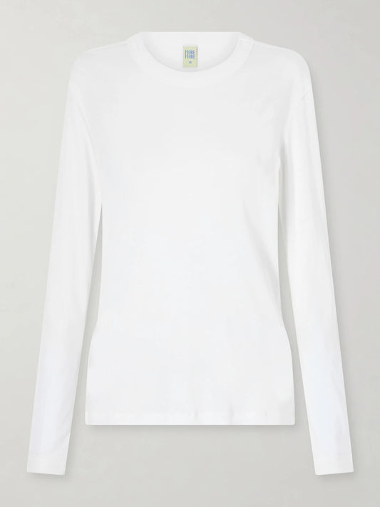 Image of a model wearing Tops. Product name - Sophie Organic Cotton-jersey T-shirt in White colour by brand - FLORE FLORE