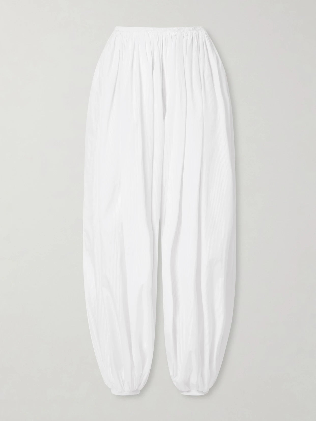 Image of a model wearing Pants. Product name - Striped Cotton-poplin Balloon Pants in White colour by brand - Alaïa
