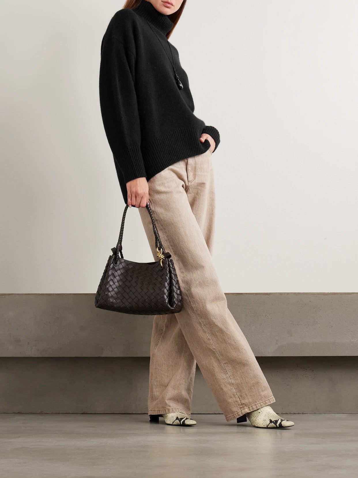 Image of a model wearing Outerwear. Product name - World's End Oversized Cashmere Turtleneck Sweater in Black colour by brand - Arch4