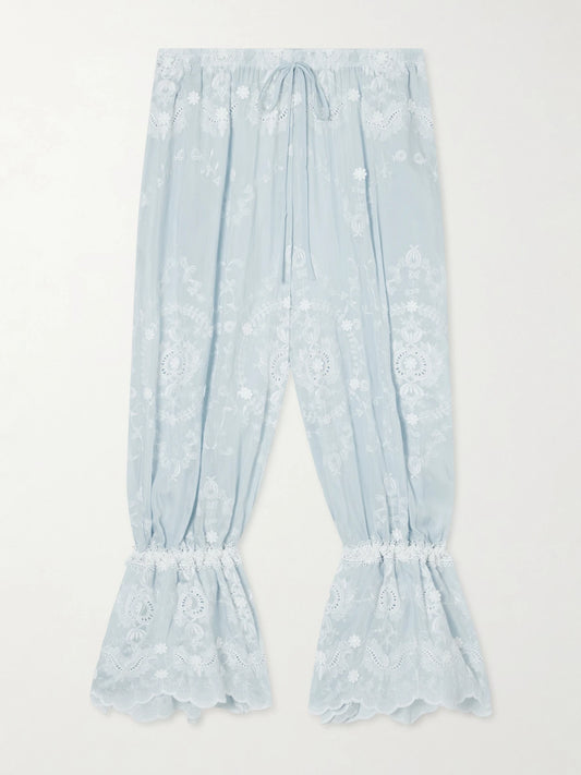 Image of a model wearing Pants. Product name - Nell Embroidered Silk-blend Balloon Pants in Blue colour by brand - Miguelina