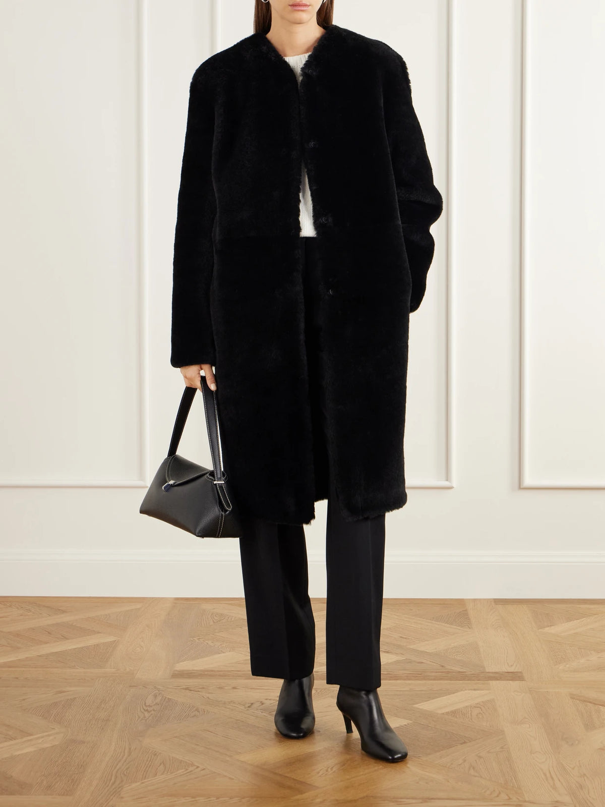 Image of Coats & Jackets. Product name - Collarless Shearling Coat in Black colour by brand - TOTEME