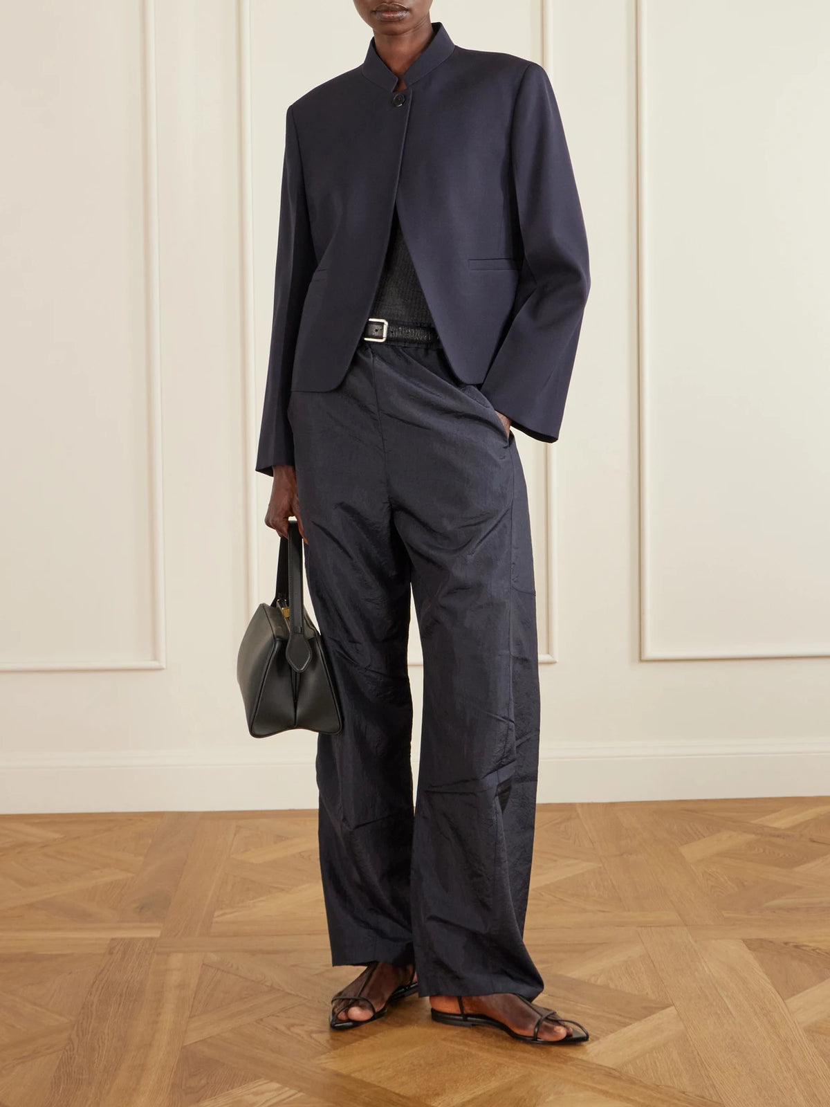 Image of a model wearing Pants. Product name - Winslow Crinkled-shell Barrel-leg Pants in Navy colour by brand - Tibi