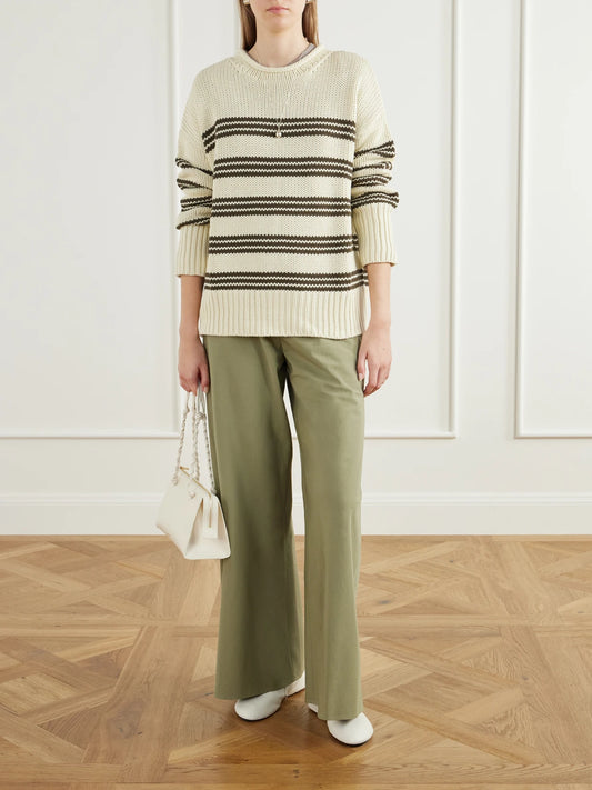 Image of a model wearing Outerwear. Product name - Marina Striped Cotton Sweater in Cream colour by brand - La Ligne