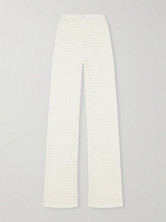 Image of a model wearing Pants. Product name - Playa Crocheted Cotton Coverup in Ecru colour by brand - Sara Cristina