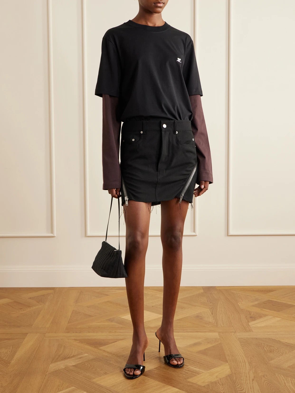 Image of a model wearing Tops. Product name - Logo-embroidered Cotton-jersey T-shirt in Black colour by brand - COURREGES