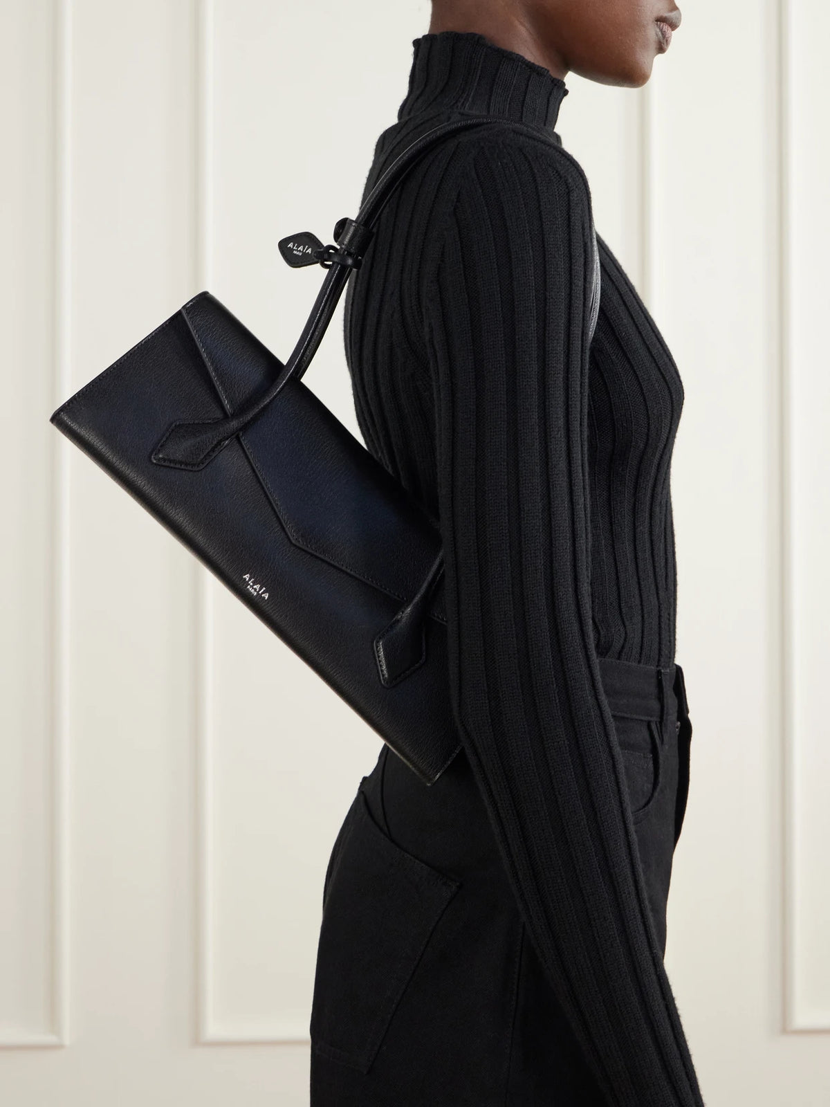 Image of Bags. Product name - Le Teckel Flat Medium Leather Shoulder Bag in Black colour by brand - Alaïa