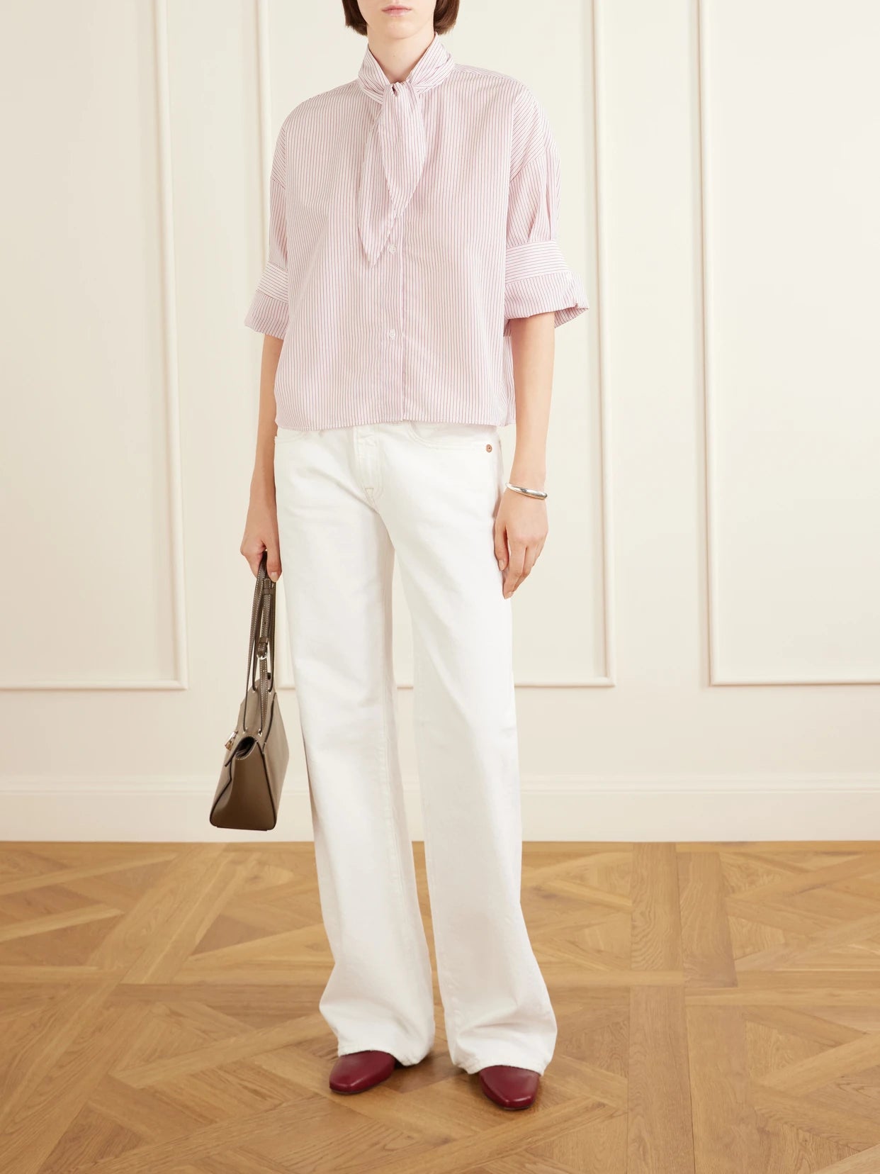 Image of a model wearing Tops. Product name - Tie One On Striped Cotton-poplin Shirt in Pink colour by brand - TWP