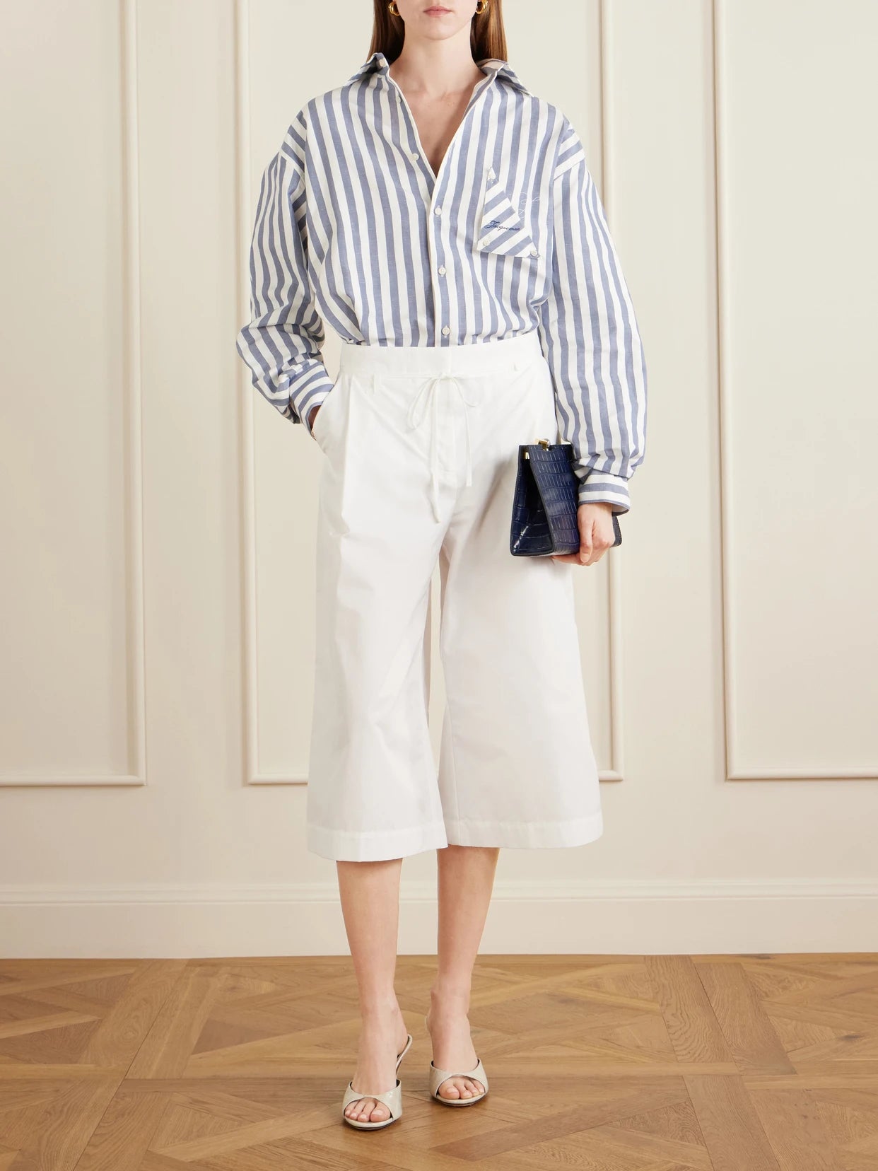 Image of a model wearing Shorts. Product name - Le Marin High-rise Cotton-poplin Wide-leg Shorts in White colour by brand - Jacquemus