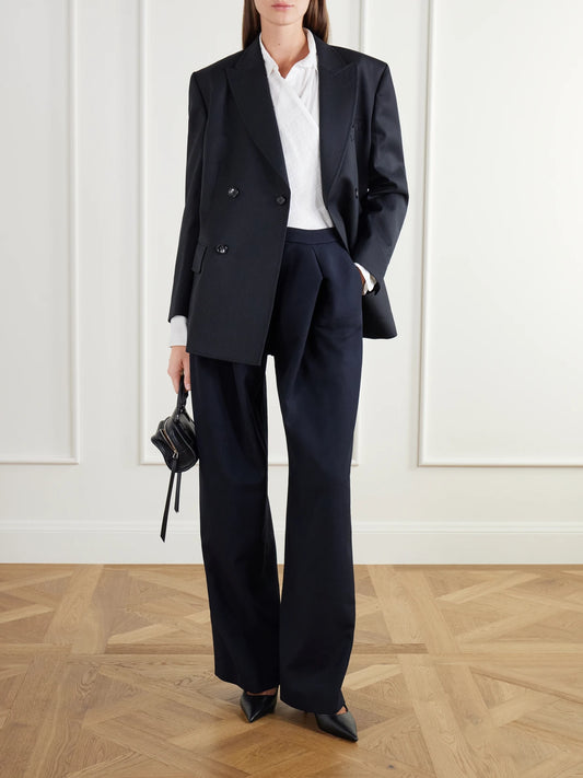 Image of a model wearing Pants. Product name - Pleated Wool-drill Wide-leg Pants in Navy colour by brand - Jean Paul Gaultier