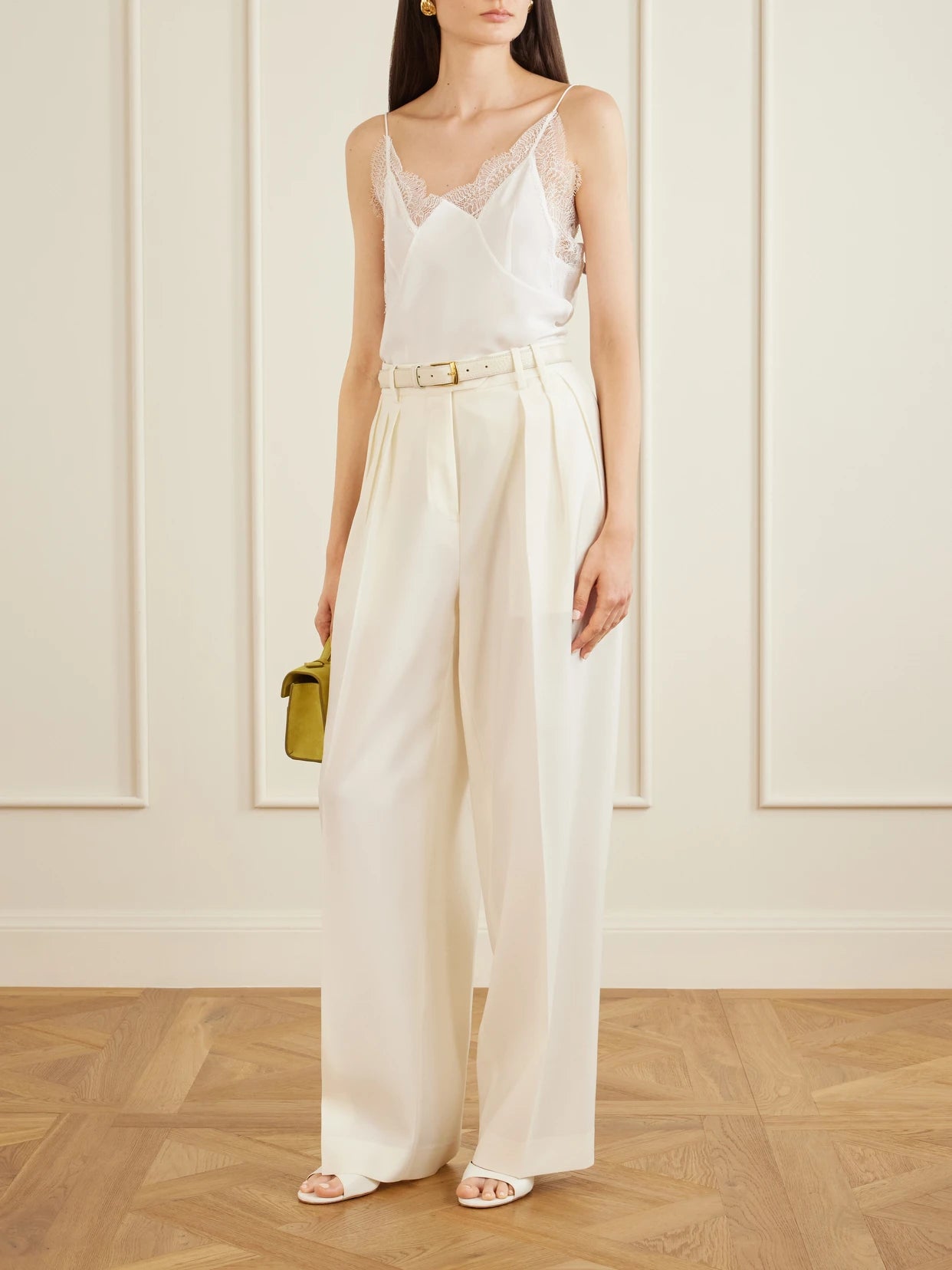 Image of a model wearing Tops. Product name - Capucines Scalloped Lace-trimmed Silk Crepe De Chine Camisole in White colour by brand - Sharon Wauchob