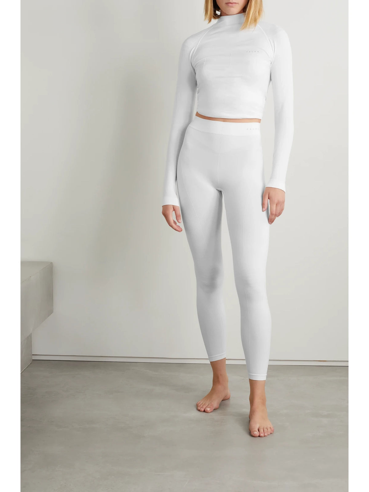 Image of a model wearing Pants. Product name - Stretch-knit Leggings in White colour by brand - FALKE Ergonomic Sport System