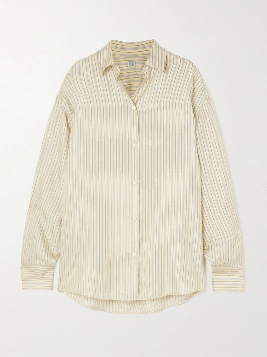 Image of a model wearing Tops. Product name - Oversized Striped Silk Shirt in Beige colour by brand - TOTEME