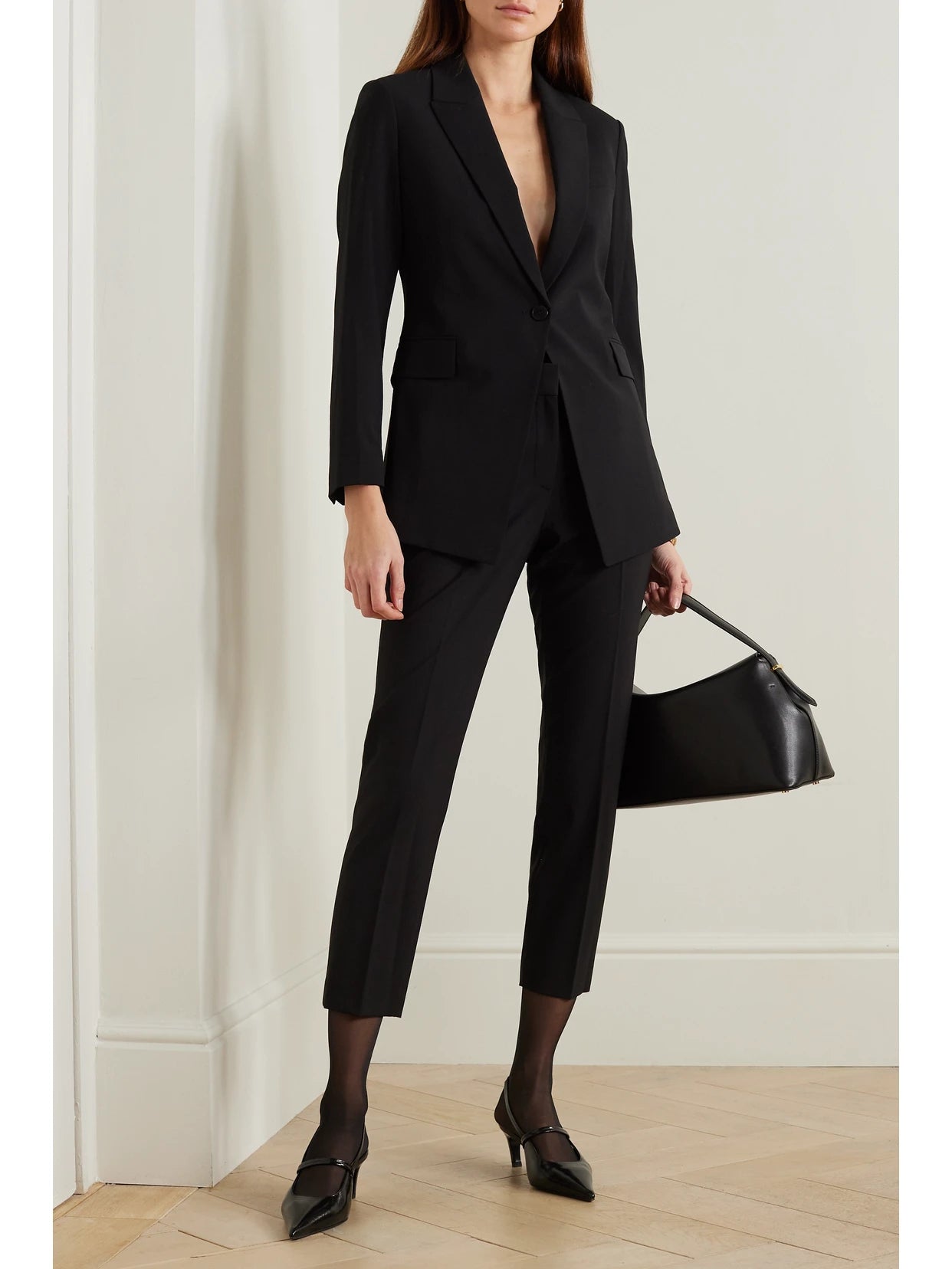 Image of a model wearing Pants. Product name - Treeca 2 Cropped Wool-blend Slim-leg Pants in Black colour by brand - Theory