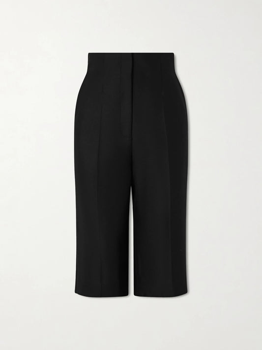 Image of a model wearing Shorts. Product name - Raelle Wool And Silk-blend Straight-leg Shorts in Black colour by brand - KHAITE