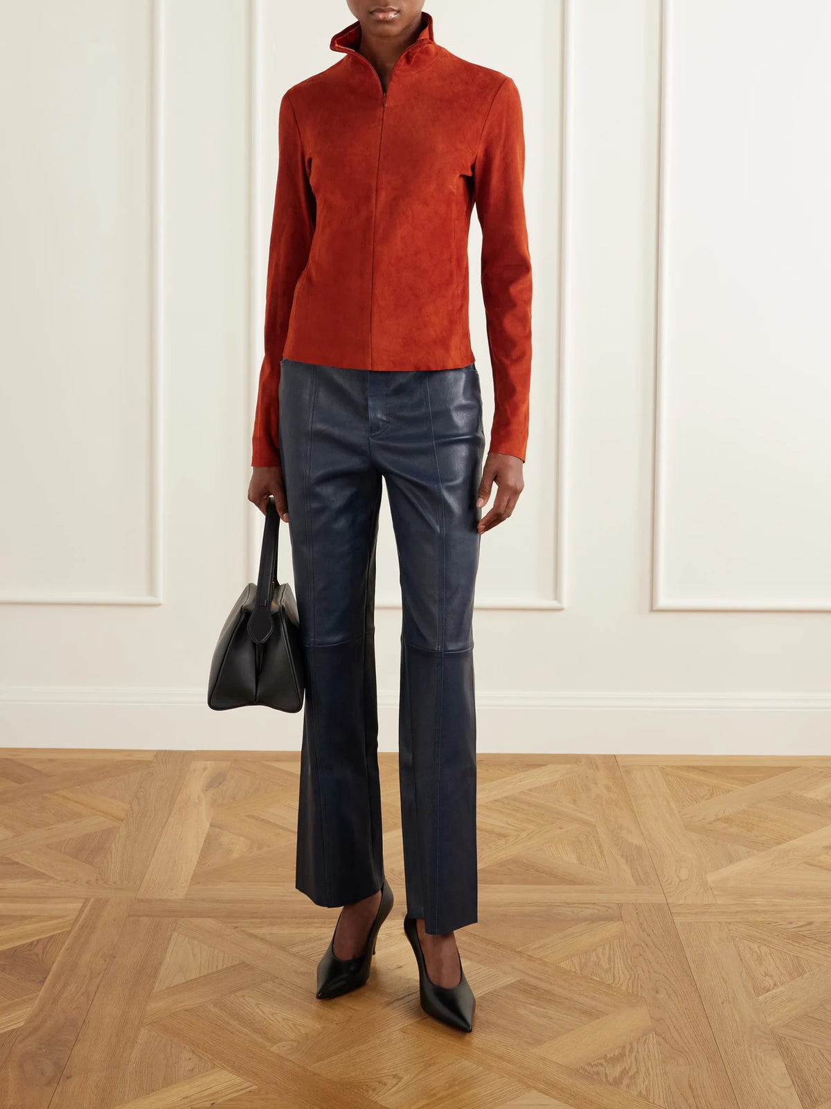 Image of a model wearing Tops. Product name - Selene Suede Turtleneck Shirt in Orange colour by brand - STOULS