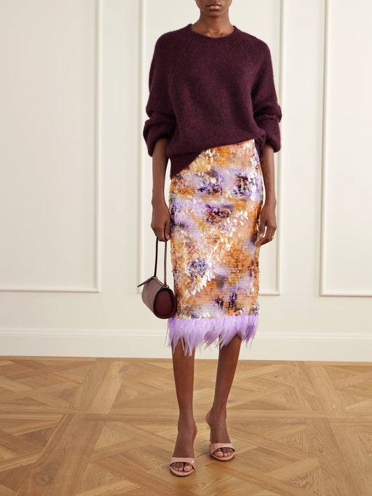 Image of a model wearing Skirts. Product name - Lark Sequin-embellished Feather-trimmed Mesh Midi Skirt in Multi colour by brand - STAUD