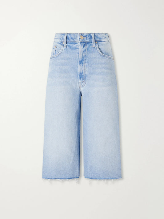 Image of a model wearing Shorts. Product name - The Whole Lot Zip Fray Low-rise Wide-leg Denim Shorts in Light denim colour by brand - Mother