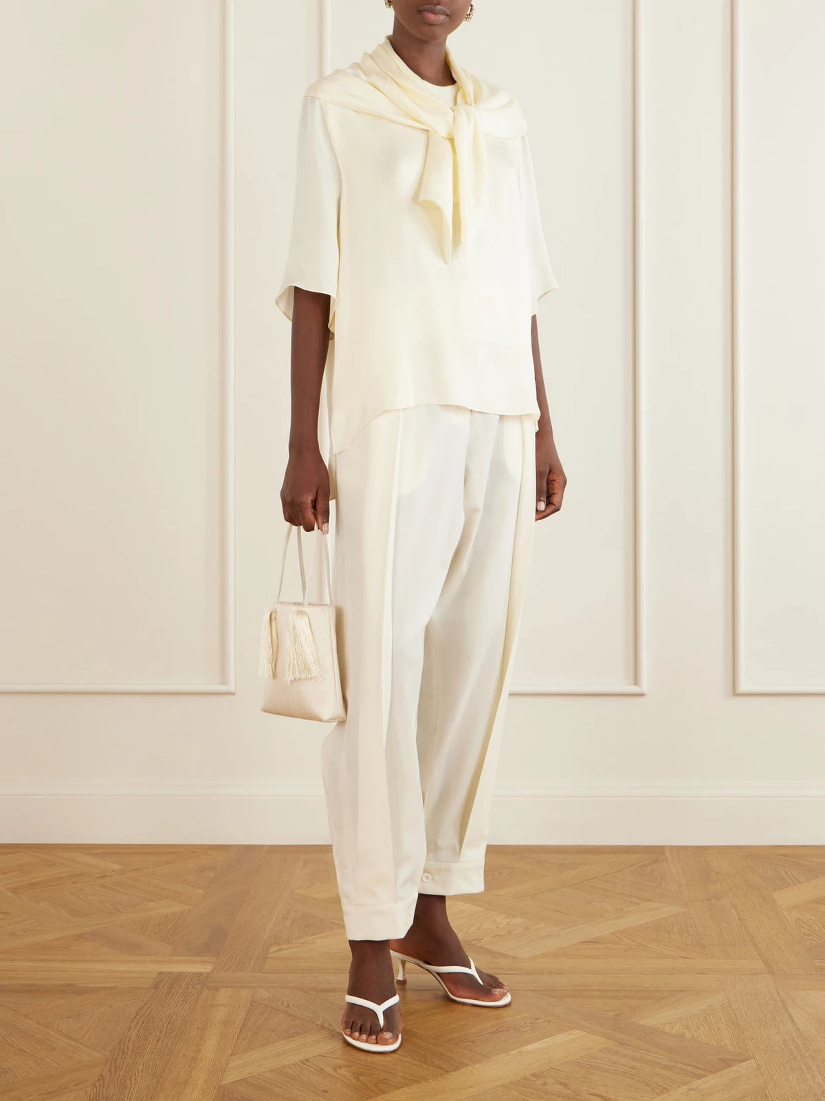 Image of a model wearing Tops. Product name - Anita Scarf-detailed Satin T-shirt in Ecru colour by brand - Sharon Wauchob