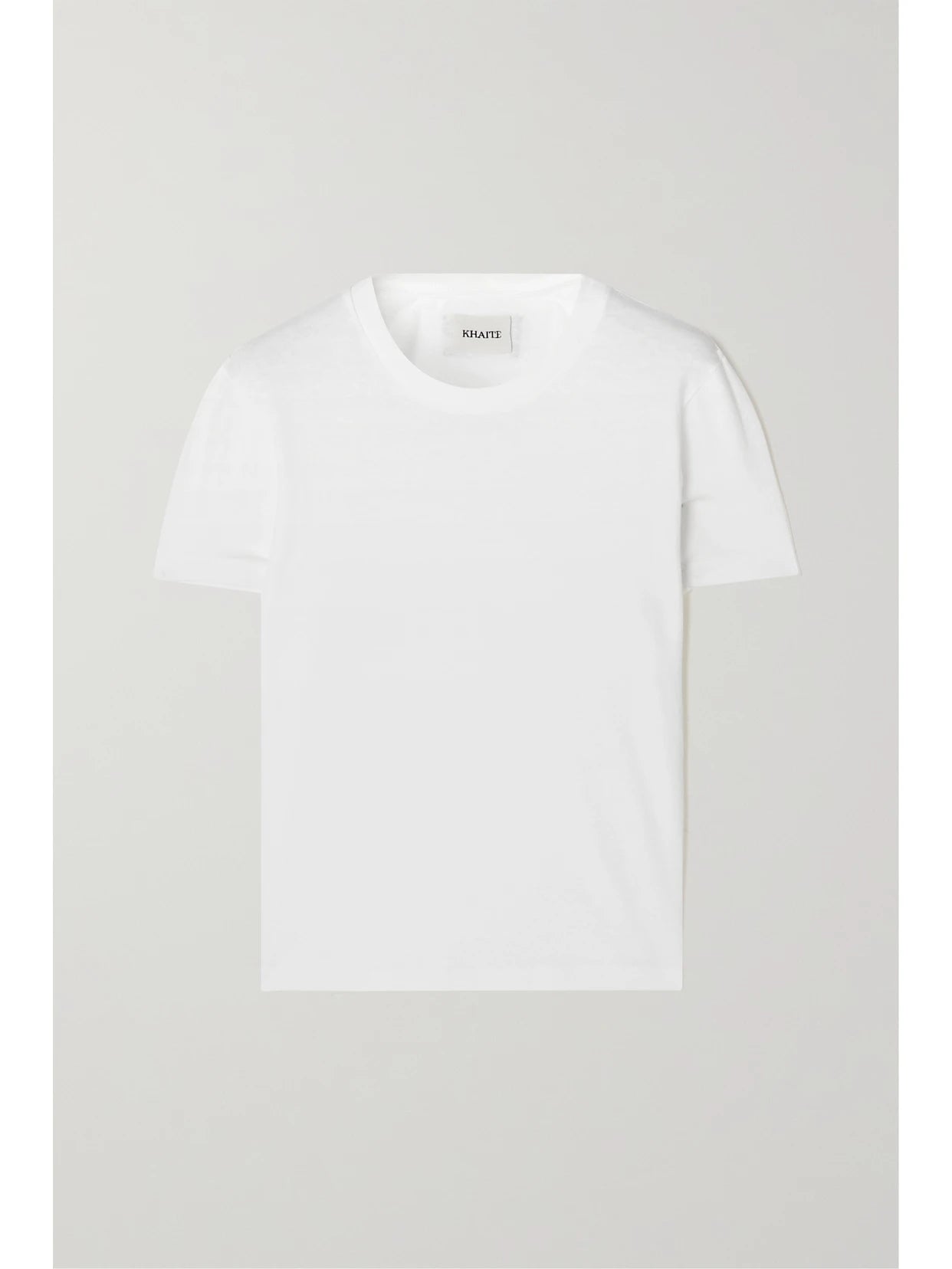 Image of a model wearing Tops. Product name - Emmylou Cotton-jersey T-shirt in White colour by brand - KHAITE