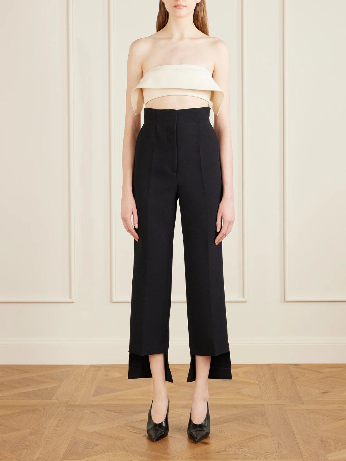 Image of a model wearing Tops. Product name - Kelsi Cropped Wool And Silk-blend Cady Top in Cream colour by brand - KHAITE