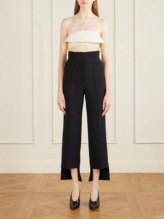 Image of a model wearing Tops. Product name - Kelsi Cropped Wool And Silk-blend Cady Top in Cream colour by brand - KHAITE