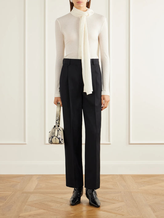 Image of a model wearing Tops. Product name - Scarf-detailed Ribbed Lyocell-blend Blouse in Ecru colour by brand - TOTEME