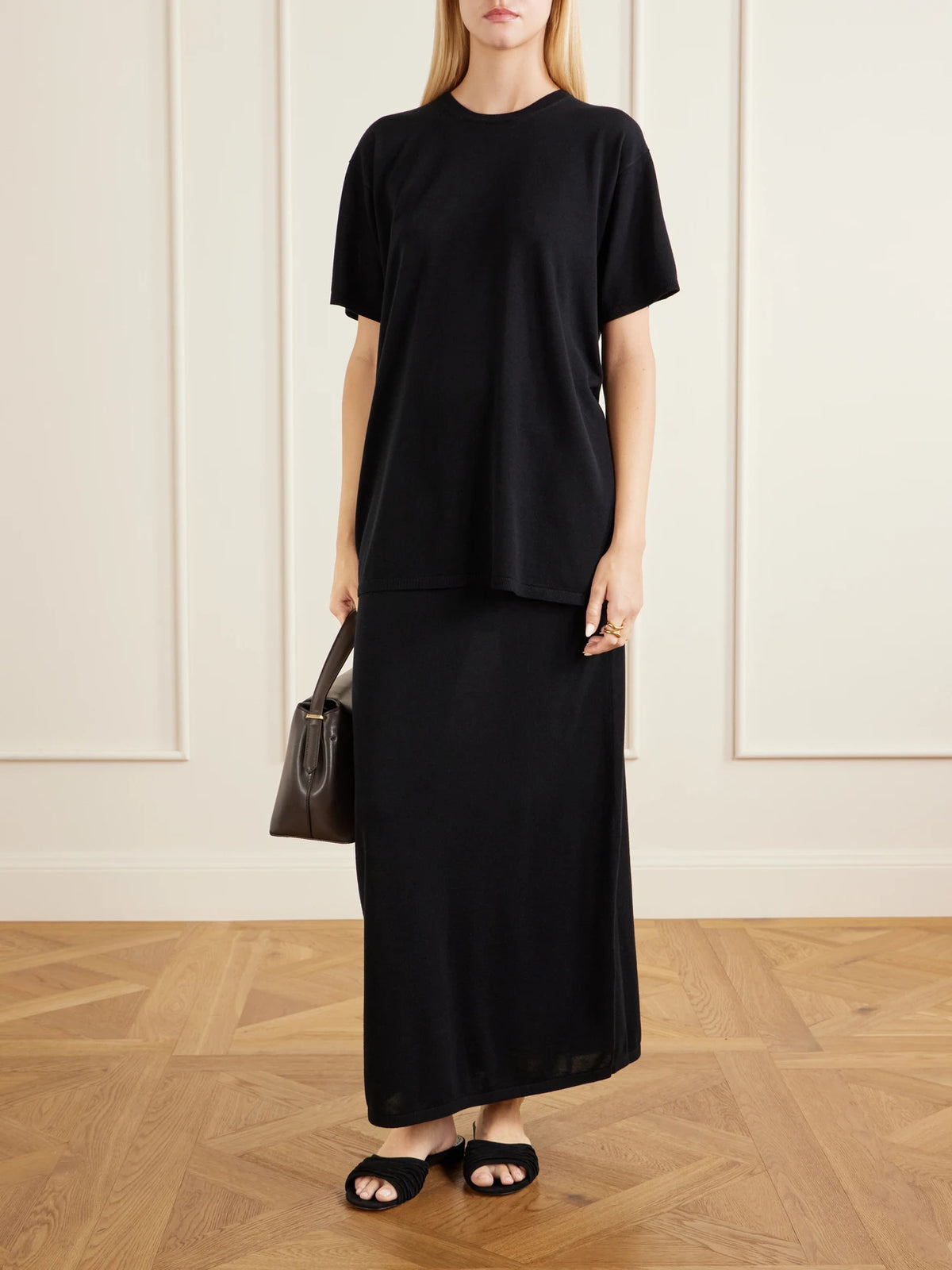 Image of a model wearing Tops. Product name - Lyocell And Cashmere-blend T-shirt in Black colour by brand - TOTEME