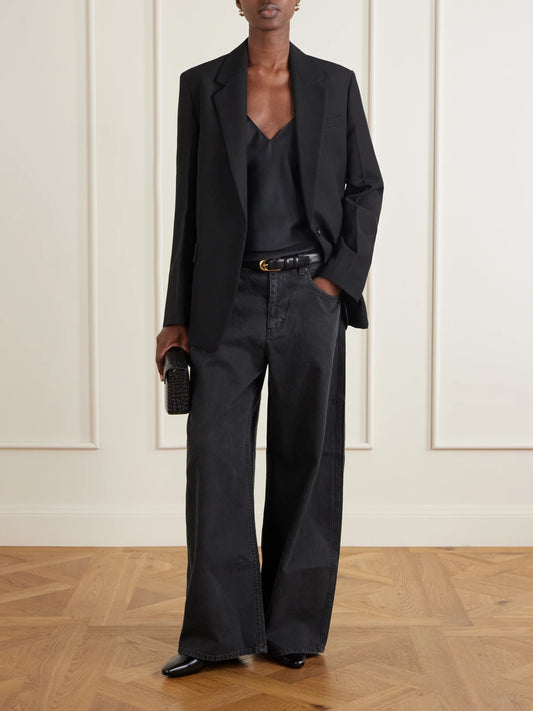 Image of a model wearing Tops. Product name - Emile Silk-satin Cami in Black colour by brand - Nili Lotan