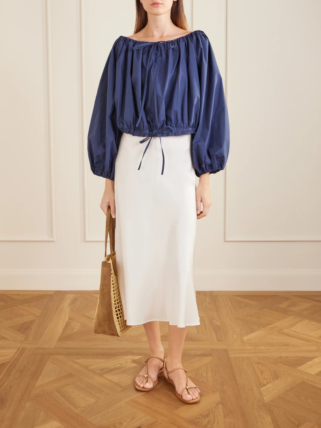 Image of a model wearing Tops. Product name - Ally Off-the-shoulder Cropped Cotton-blend Blouse in Navy colour by brand - BERNADETTE